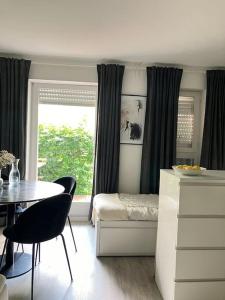 a bedroom with a bed and a table and a window at Stilvolle Wohnung in Offenburg in Offenburg