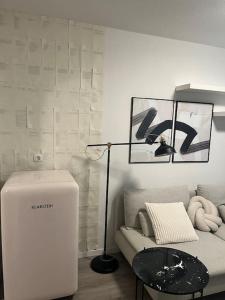 a living room with a couch and a lamp and a table at Stilvolle Wohnung in Offenburg in Offenburg