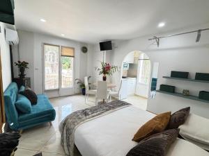 a bedroom with a large bed and a blue couch at Villa Belle Epoque Saint-Raphaël in Saint-Raphaël +73 photos