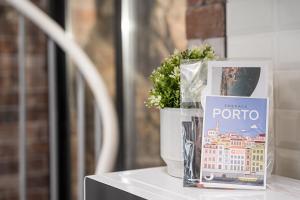 a vase with a plant and a book on a table at GuestReady - Serene Hideout in Downtown in Porto +34 photos