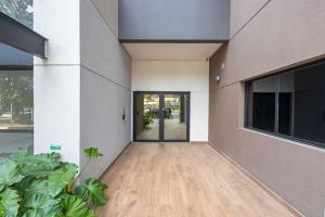 an empty entrance to a building with a wooden floor at Yume B Side Pinheiros in Sao Paulo