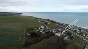 an aerial view of a field and the ocean at dday cottage gold beach in Saint-Côme-de-Fresné
