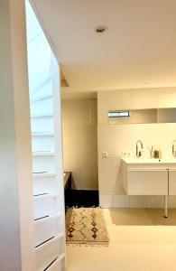 a bathroom with a sink and a toilet and a mirror at Houseboat PURE II in Vreeland +42 photos