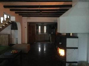 a living room with a fire in the fireplace at Casa Din Deal in Podişu +1 photo