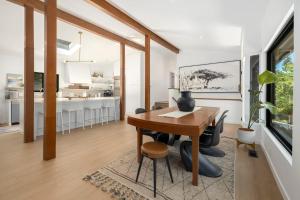 a kitchen and dining room with a wooden table in a room at Lucille-5 Min to DT & UofA-Serene Nature Views in Fayetteville