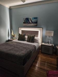 a bedroom with a bed and a lamp on a table at Luxury Designer Villa by the Beach Bright Beautiful Brand New in Galveston