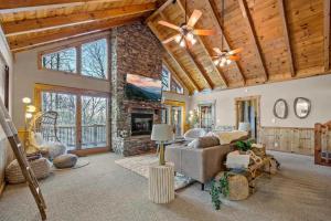 a living room with a couch and a fireplace at Round Top Way Cabin By Beyond Expectations in Sevierville