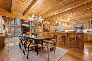a kitchen and dining room with a table and chairs at Round Top Way Cabin By Beyond Expectations in Sevierville