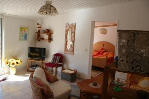 a living room with a couch and a bedroom at Schöntal- Seen- und Felsen in Ludwigswinkel