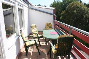 a patio with chairs and a table on a balcony at Schöntal- Seen- und Felsen in Ludwigswinkel