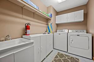 a kitchen with white cabinets and a stove and a sink at Round Top Way Cabin By Beyond Expectations in Sevierville +82 photos