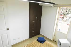 a room with a door and a blue pillow on the floor at Acogedor apartamento en caracas in Caracas +26 photos