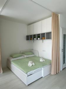 a bedroom with a bed with two towels on it at Azure Bay Residence in Balatonfenyves