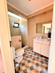 a bathroom with a toilet and a sink and a mirror at Akonxego&Cia in Mourão +40 photos