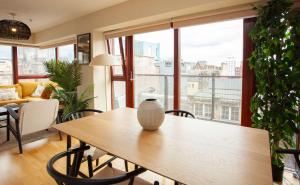 a wooden table with a vase on it in a living room at Beautiful Penthouse in City Centre Location in Glasgow +21 photos