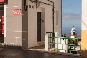 a building with a clock tower in the distance at El Hierro Bed & Urban II in Valverde