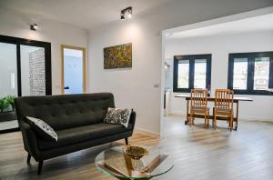 a living room with a couch and a table at El Hierro Bed & Vintage in Valverde