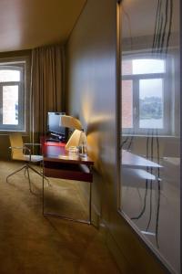 a room with a desk with a computer and two windows at Pestana Palácio do Freixo, Pousada & National Monument - The Leading Hotels of the World in Porto
