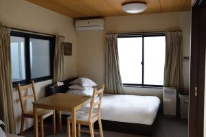 Postel nebo postele na pokoji v ubytování Miyanonoki Toji Kyoto