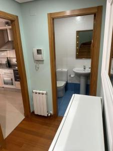 a bathroom with a toilet and a sink at Increíble dúplex en Lugo in Lugo +17 photos