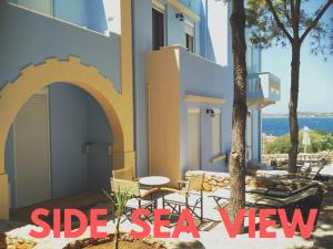 a building with a patio with a table and chairs at Giorgi's Blue Apartments in Kalathas