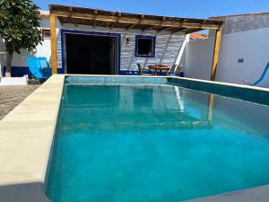 a swimming pool in the backyard of a house at Casa da Oriola in Oriola