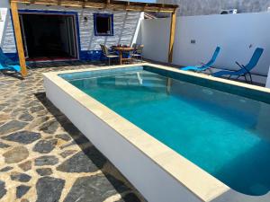 a swimming pool with blue water in a house at Casa da Oriola in Oriola