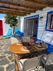 a wooden table and chairs on a patio at Casa da Oriola in Oriola