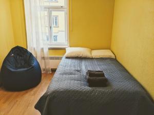 a small bedroom with a bed and a window at Peaceful studio with desk & free parking near city center in Tallinn