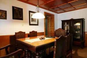 a dining room with a wooden table and chairs at Gästehaus Sonnenheim, Friedenweiler, Titisee in Friedenweiler