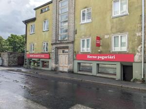 a building with a home repair sign on the side of a street at Peaceful studio with desk & free parking near city center in Tallinn