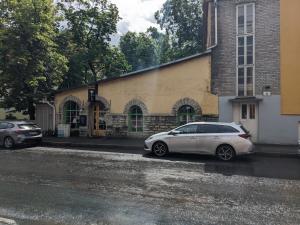 a white car parked in front of a building at Peaceful studio with desk & free parking near city center in Tallinn
