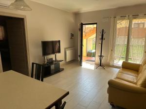 a living room with a couch and a television at Casa dolce casa in Trecastagni