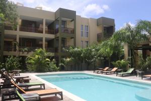 a swimming pool in front of a building at LOL-HA Hotel Boutique in Cancún