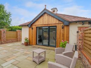 a garden room with sliding glass doors and a patio at Studio in Chester