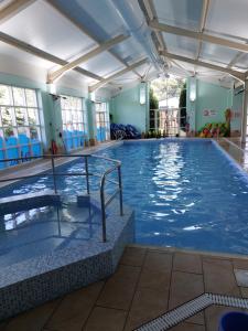 a large indoor swimming pool with blue water at Bird's Bay cresswell towers in Cresswell
