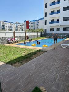 a group of people playing in a swimming pool at Nour Beach Cabo in Martil +19 photos