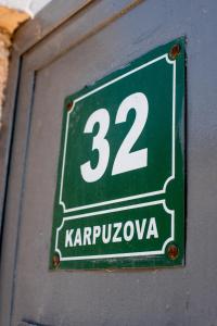 a green sign with the number on it at Colours Plus in Sarajevo