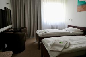 Ένα ή περισσότερα κρεβάτια σε δωμάτιο στο Hotel Merkur - Jablonec nad Nisou