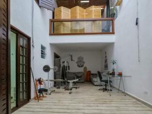 an office with a balcony and a desk in a building at Casa do sol in Sao Paulo