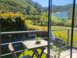 a table and chairs on a balcony with a view at Comfort Campestre in Tabio +19 photos