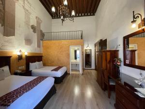 Postel nebo postele na pokoji v ubytování Hotel Historia