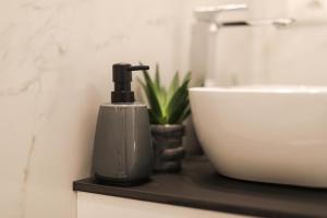 a soap dispenser on a black counter in a bathroom at MagicFlo Santa Croce Appartamento in Florence +39 photos
