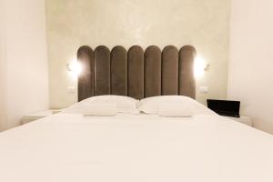 a bedroom with a large bed with two white pillows at MagicFlo Santa Croce Appartamento in Florence