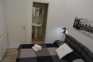 a bedroom with a black and white bed and a sink at Casa Amabile in Rome +37 photos