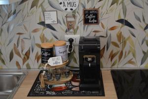 a coffee maker with two coffee cups on a counter at Casa Amabile in Rome