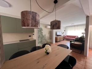 a living room with a wooden table and chairs at ALMA de Bardenas in Arguedas
