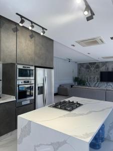 a kitchen with a white counter top and a stove at Maria La Rosa By Seahorse in Al Baḩḩāth