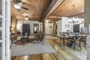 a dining room and living room with a table and chairs at The Log Palace Private Guest Suite in White House