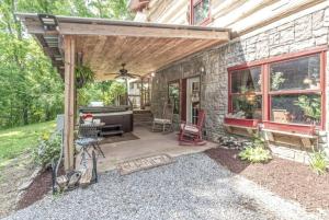 a stone house with a patio with a piano at The Log Palace Private Guest Suite in White House